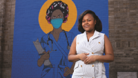 Pascale Chatalgne in front of nurse mural.